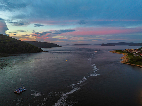 Aerial sunrise waterscape with boats, colour and clouds