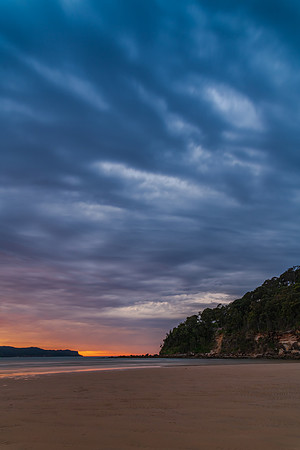 Colourful cloud filled sunrise at the seaside