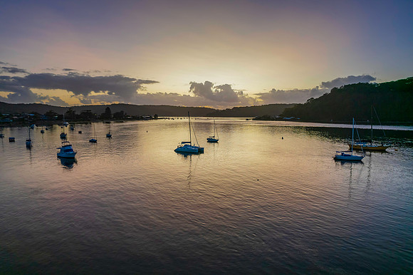 Aerial sunrise waterscape with boats