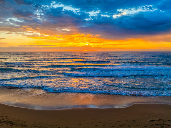Pretty Sunrise at the seaside with rain clouds