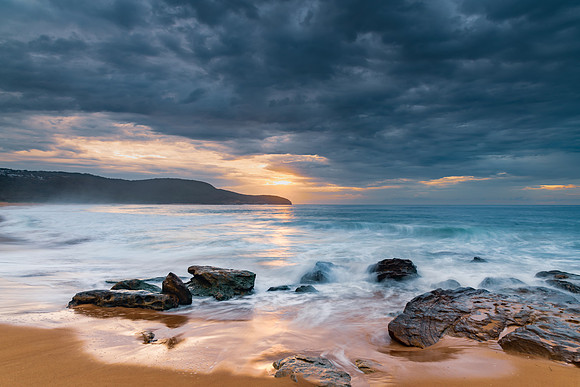 Sunrise at the seaside with rocks and beautiful diffused light b