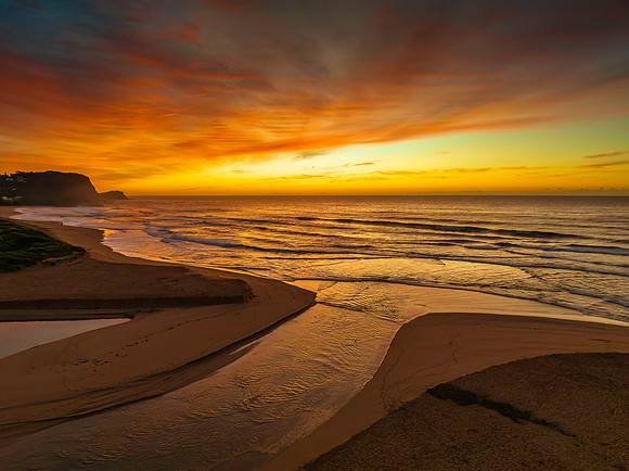 Sunrise and high cloud cover by the sea and lagoon