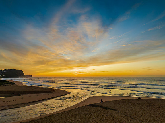 Sunrise and high cloud cover by the sea and lagoon