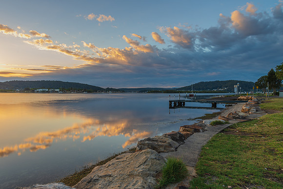 Sunrise waterscape with cloud reflections