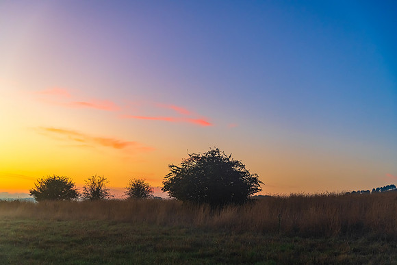 Sunrise over the countryside on the outskirts of country town wi