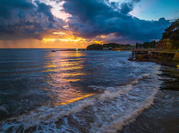 Aerial sunrise at the seaside with rain clouds