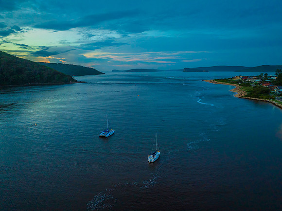 Aerial sunrise waterscape with boats, colour and clouds