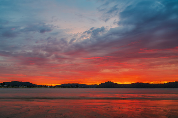 Colourful cloud filled sunrise at the seaside