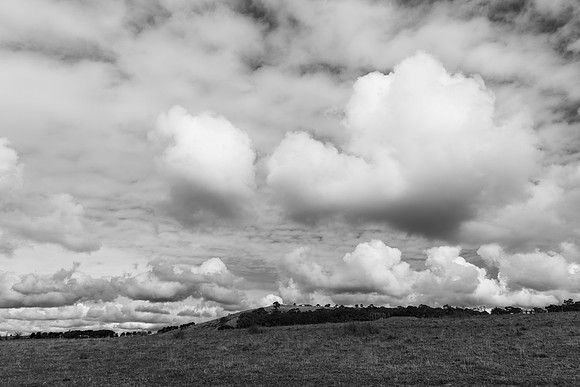 Low and medium clouds over the countryside in monochrome