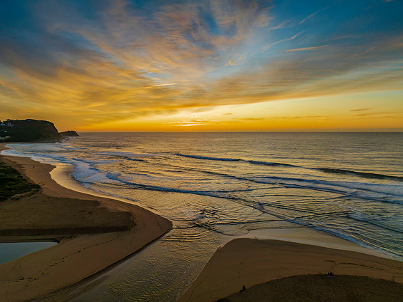 Sunrise and high cloud cover by the sea and lagoon
