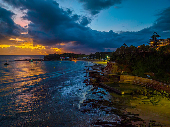 Aerial sunrise at the seaside with rain clouds