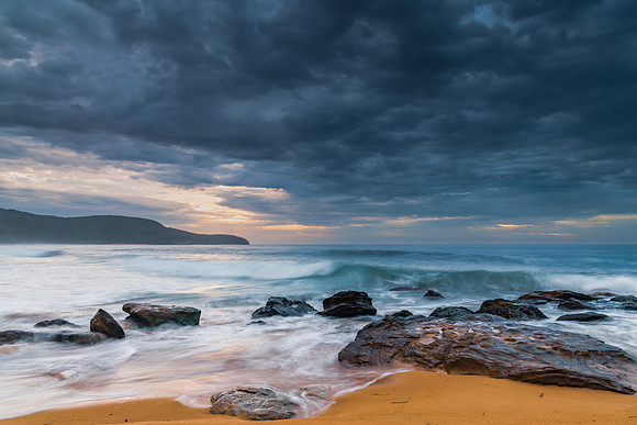 Sunrise at the seaside with rocks and beautiful diffused light b