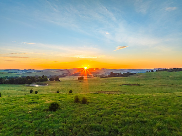Sunrise over the countryside on the outskirts of country town wi