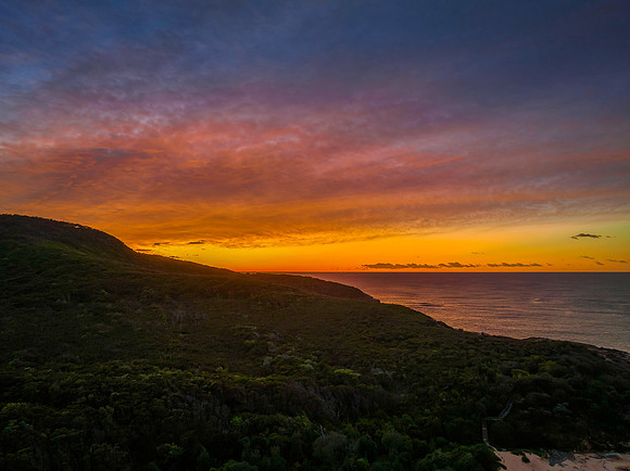 High cloud sunrise over the beach and mountain