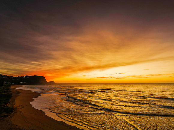 Sunrise and high cloud cover by the sea and lagoon