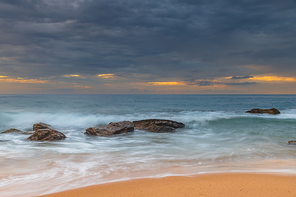 Sunrise at the seaside with rocks and beautiful diffused light b