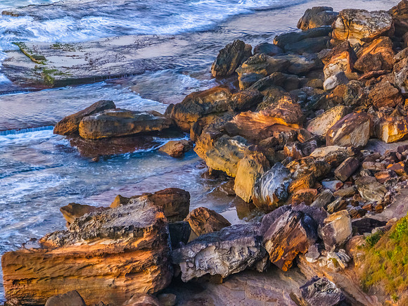 Sunrise top down seascape with rocks