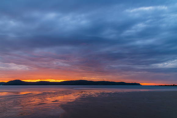 Colourful cloud filled sunrise at the seaside