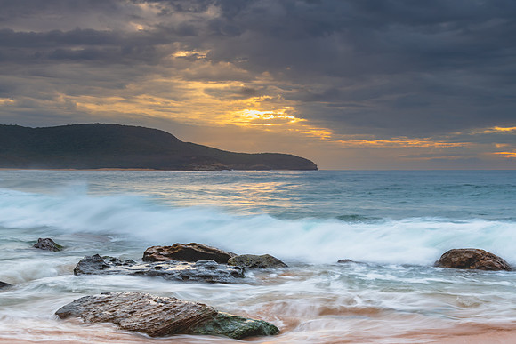 Sunrise at the seaside with rocks and beautiful diffused light b