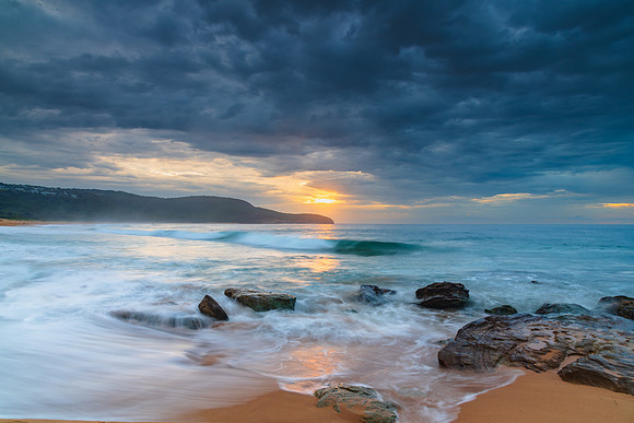 Sunrise at the seaside with rocks and beautiful diffused light b