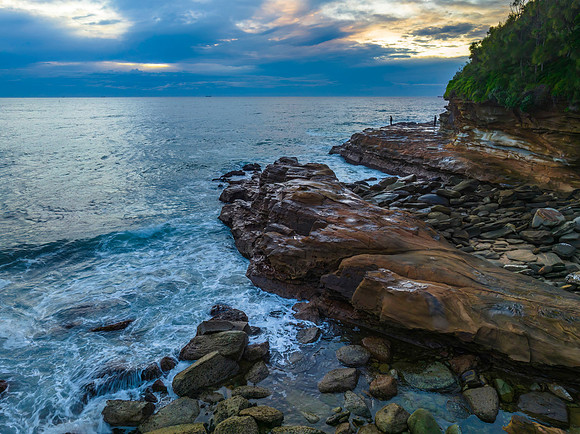 Aerial sunrise at the seaside in shades of blue and grey