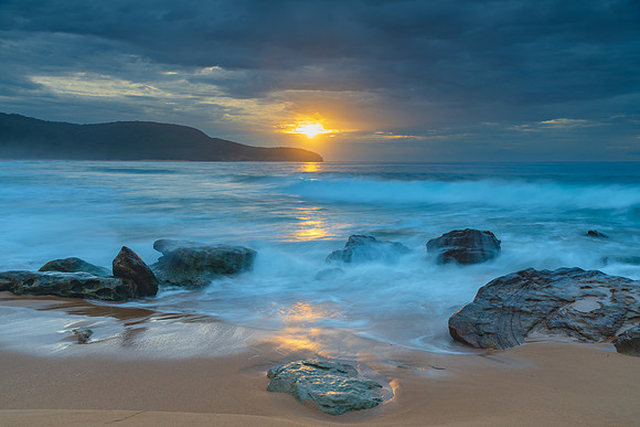 Sunrise at the seaside with rocks and beautiful diffused light b