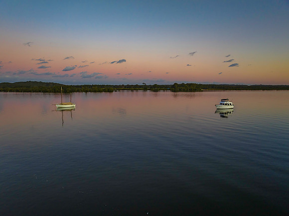 Sunset over the river with boats
