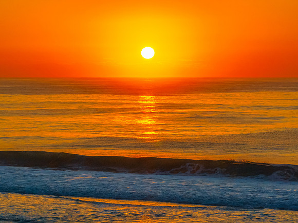 Aerial sunrise at the beach with clear skies