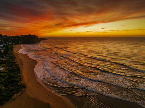 Sunrise and high cloud cover by the sea and lagoon