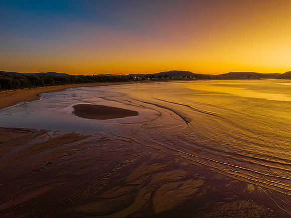 Aerial sunrise seascape with orange glow on a cold Winter's morn