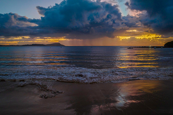 Aerial sunrise at the seaside with rain clouds