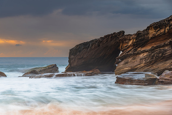 Sunrise at the seaside with rocks and beautiful diffused light b