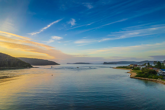 Aerial sunrise waterscape with boats