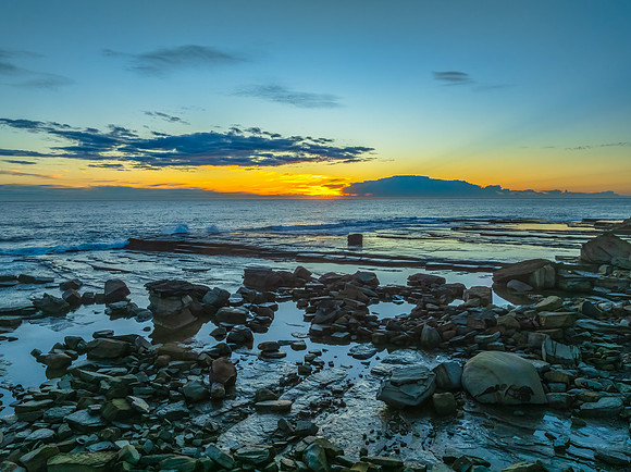 Sunrise over the ocean and rocky Inlet