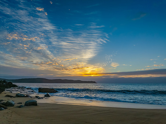 Sunrise, clouds and surf at the seaside
