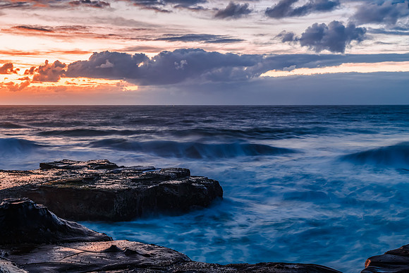 Sunrise, sea, waves, clouds and tessellated rock platform