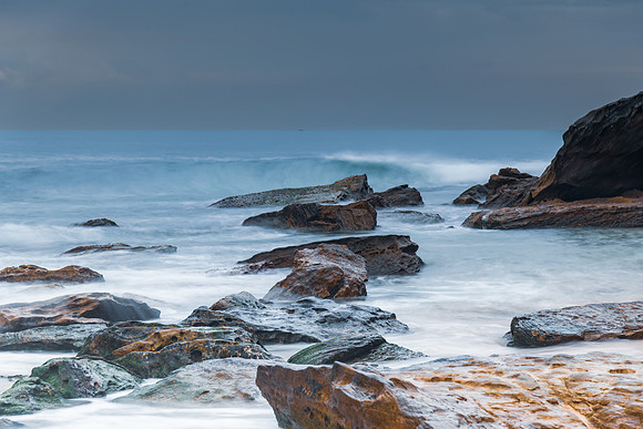 Sunrise at the seaside with rocks and beautiful diffused light b