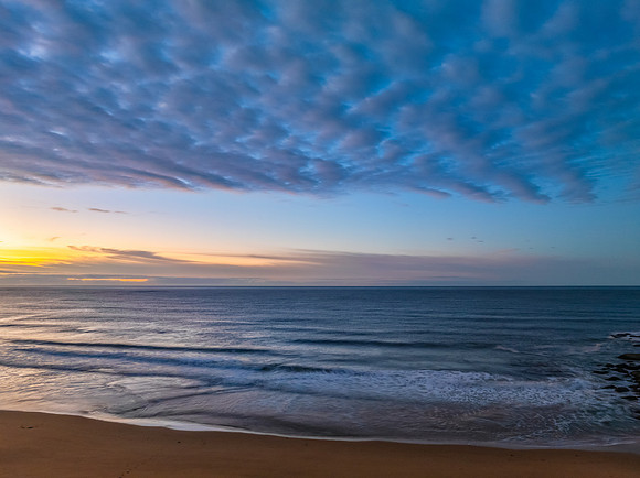 Winter seascape views over the beach with high and medium cloud