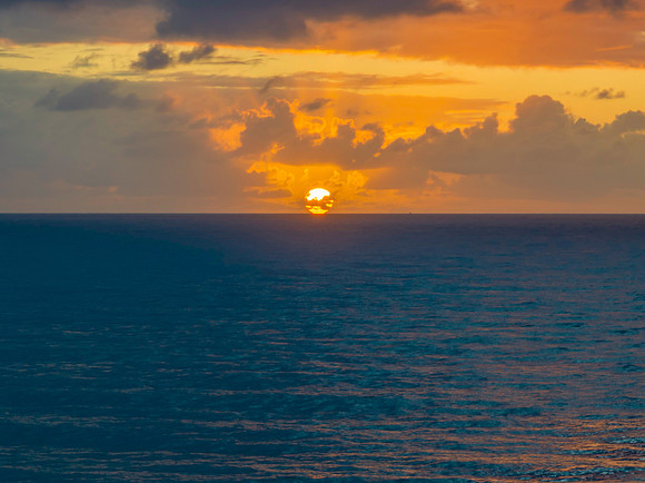 Drizzly moody sunrise seascape with cloud filled sky