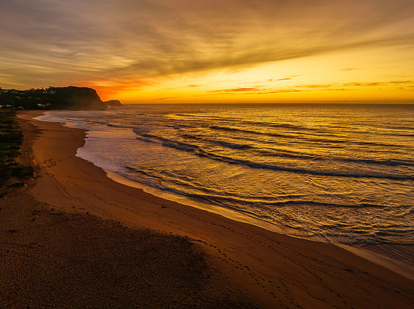 Sunrise and high cloud cover by the sea and lagoon