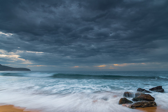 Sunrise at the seaside with rocks and beautiful diffused light b