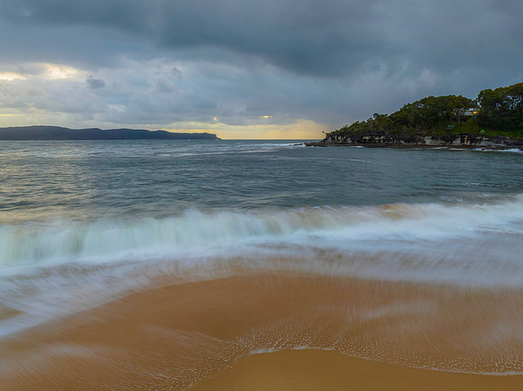 Sunrise seascape with overcast sky and rain clouds