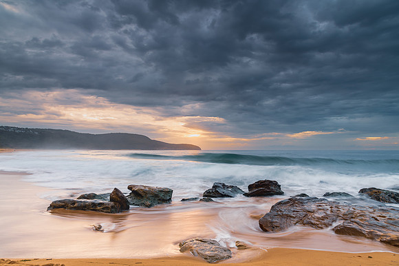 Sunrise at the seaside with rocks and beautiful diffused light b