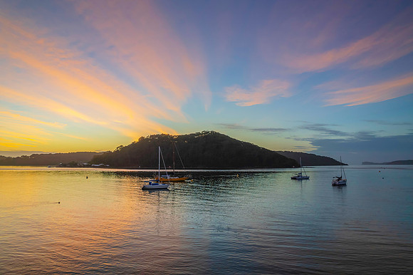 Aerial sunrise waterscape with boats