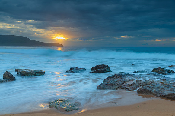 Sunrise at the seaside with rocks and beautiful diffused light b