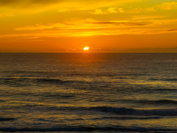 Sunrise and high cloud cover by the sea and lagoon