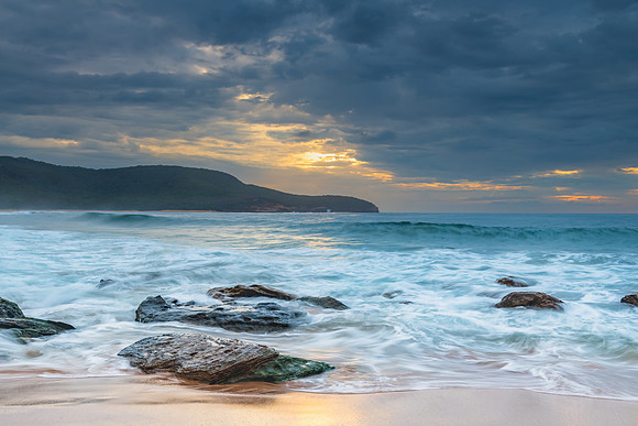 Sunrise at the seaside with rocks and beautiful diffused light b