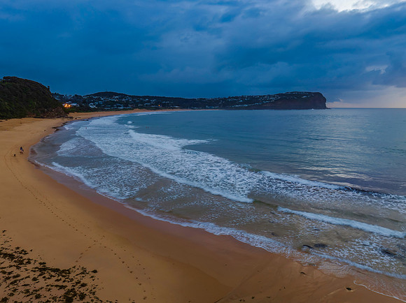 Drizzly moody sunrise seascape with cloud filled sky