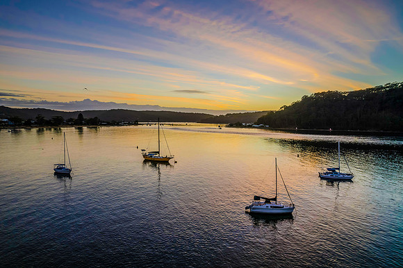 Aerial sunrise waterscape with boats
