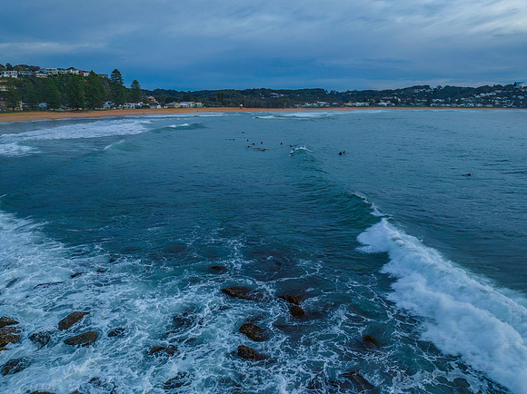 Aerial sunrise at the seaside in shades of blue and grey
